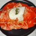 Ground beef, bean and cheese, enchilada style red topped with an egg.