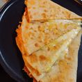 Organic fresh made flour tortilla filled with Tillamook cheddar cheese, seared on griddle with real butter.